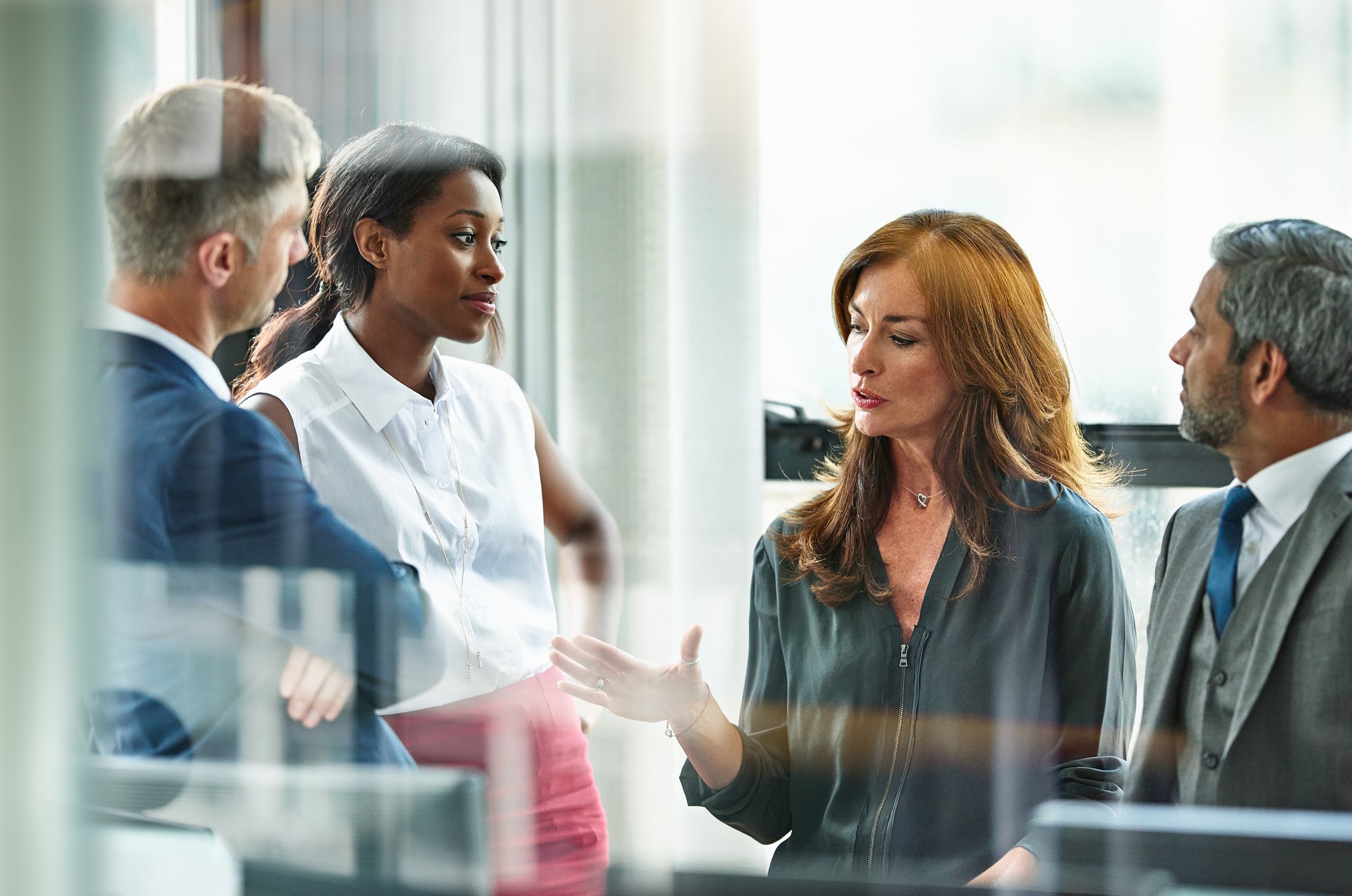 Female business executive leading team meeting