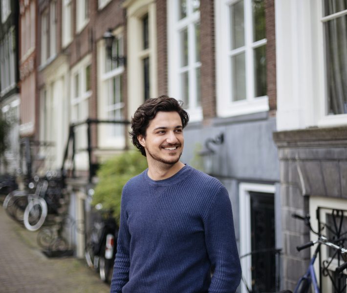 Portrait of a young handsome man on the streets of Amsterdam
