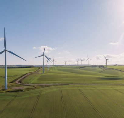 Drone view of a wind farm. Multiple wind turbines. A sunny day.