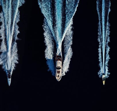 High angle view of three speed boats speeding in open waters side by side