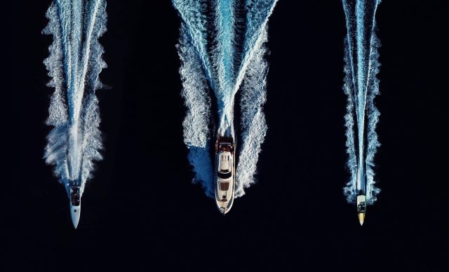 High angle view of three speed boats speeding in open waters side by side