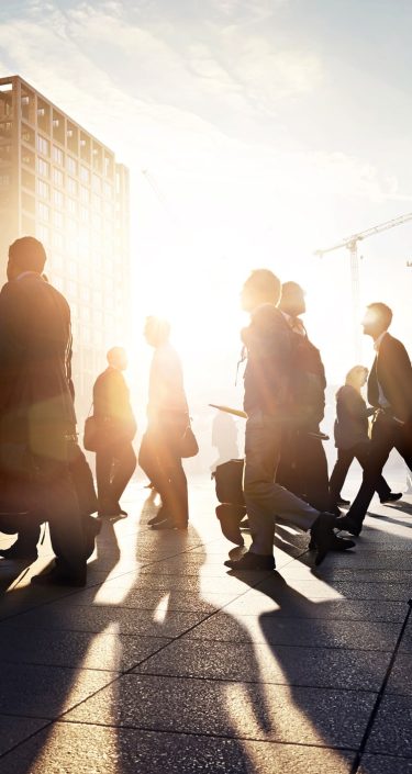 Business people walking to work in the city at sunrise.jpg