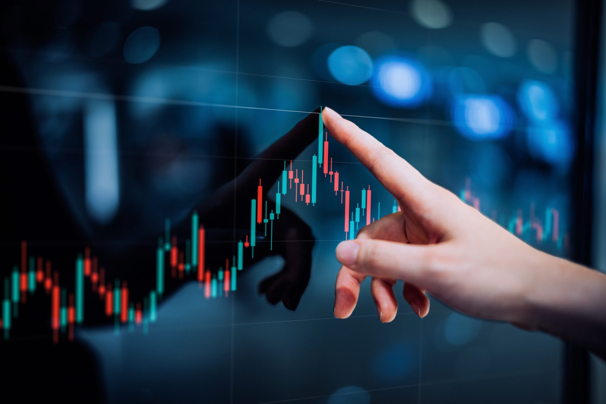 Close up of female hand touching stock market analysis digital display screen