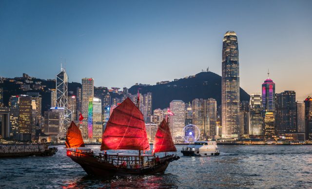 Traditional junk boat sailing across Victoria Harbour, Hong Kong.