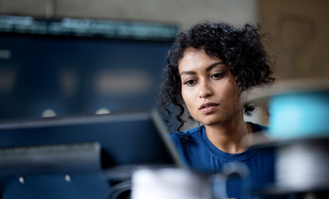 female software engineer on software project development to analyzing and ensuring reliability in a tech business office