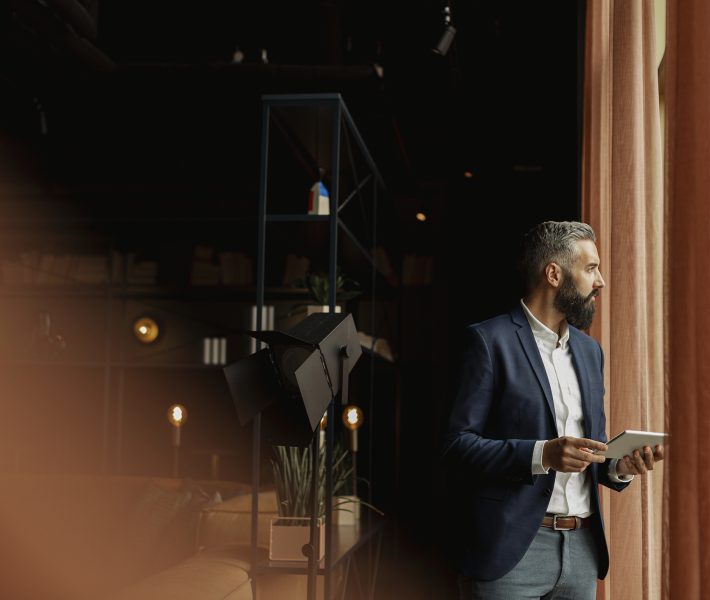 Businessman in cafe holding digital tablet