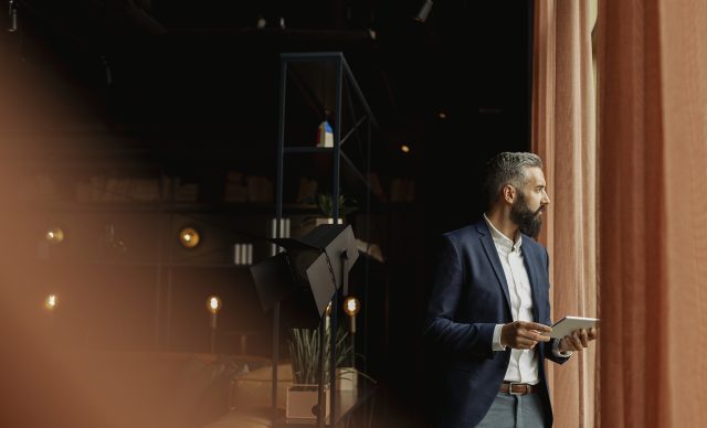 Businessman in cafe holding digital tablet