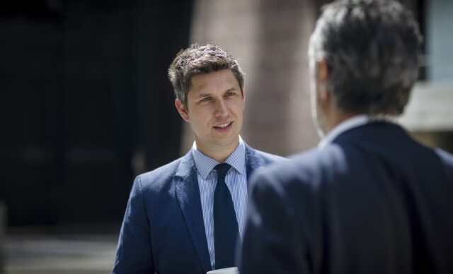 Two businessmen talking on city street