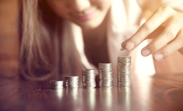 Asia business woman saving money for invest